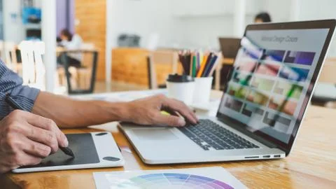 Young creative graphic designer working on project architectural drawing and Stock Photos