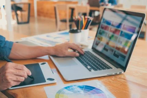 Young creative graphic designer working on project architectural drawing and Stock Photos