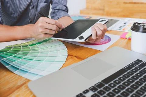 Young creative graphic designer working on project architectural drawing and Stock Photos