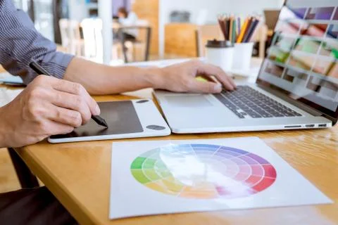Young creative graphic designer working on project architectural drawing and Stock Photos