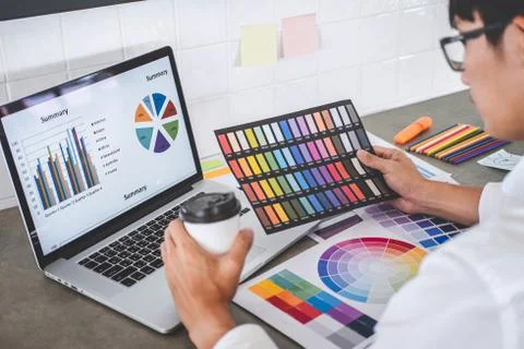 Young creative graphic designer working on project architectural drawing and Stock Photos