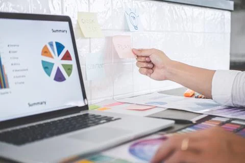 Young creative graphic designer working on project architectural drawing and Stock Photos