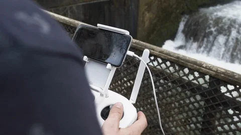 Young Creative handling a drone at a waterfall Vidéo 102294352