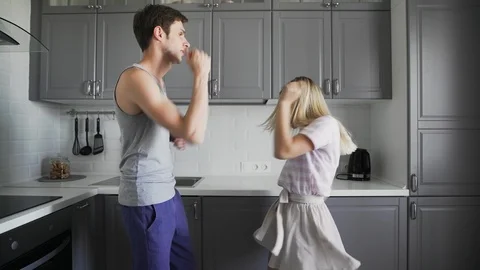 Young creative hipster couple dancing together in the kitchen at home. Fancy Stock Footage 127484116