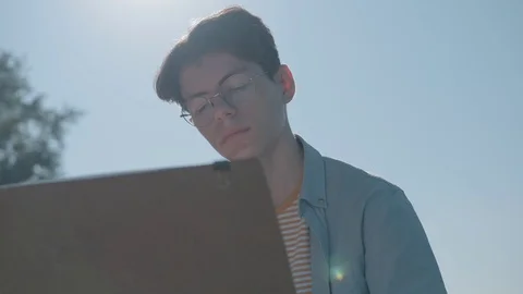 Young creative man 20-25 years old draws in a summer city park Video stock 114060853