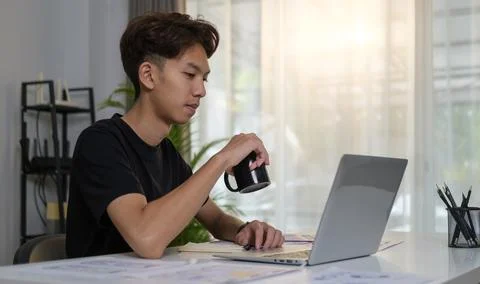 Young creative man using laptop, planning application development at office.. Stock Photos