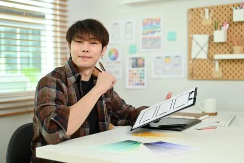 Young creative man ux developer creating sketches of applications for mobile Stock Photos