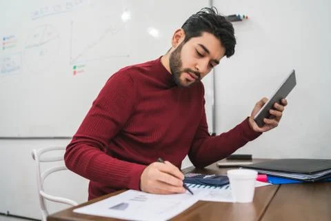 Young creative man working with his digital tablet. Stock Photos