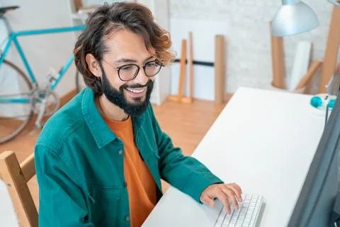 Young creative man working in modern office with new startup project at studio Stock Photos