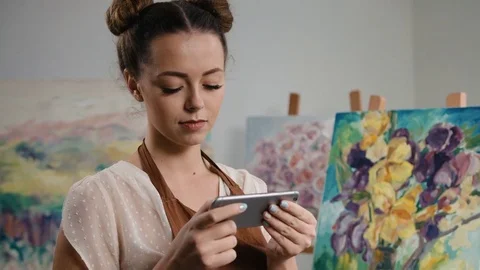 Young creative painter resting after long working day in art studio, holding Stock Footage 74210139
