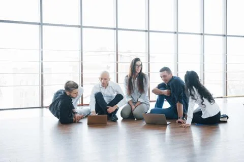 Young creative people in modern office. Group of young business people are wo Stock Photos