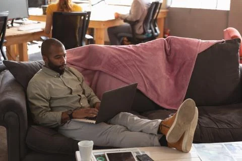 Young creative professional man working in a sunlit office Stock Photos