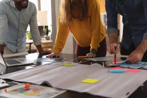 Young creative professionals working in a sunlit office Stock Photos