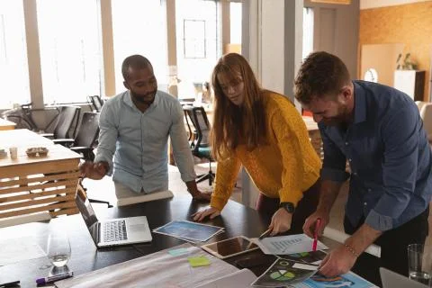 Young creative professionals working in a sunlit office Fotos Stock