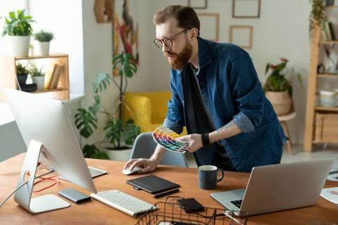 Young creative software developer or web designer bending over wooden table Stock Photos