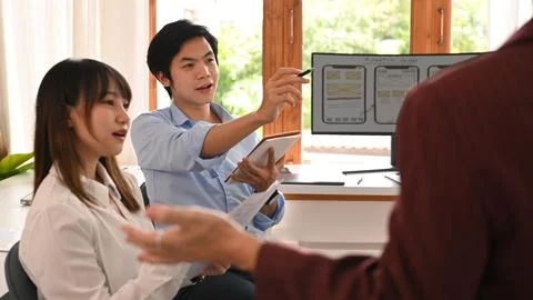 Young creative team brainstorming, working together on mobile application 写真素材
