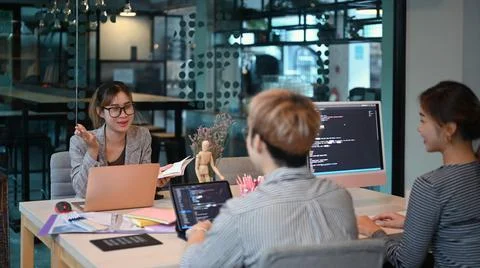 Young creative team of designer developing a new project in modern office Stock Photos