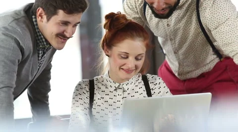 Young creative team discussing plans and high-fiving Stock Footage 59542839