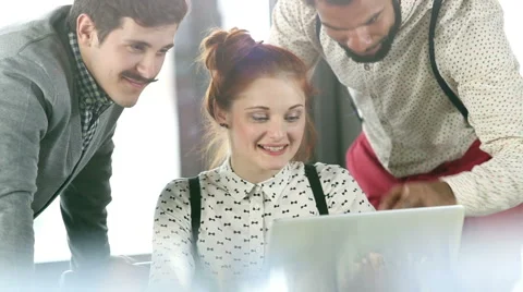 Young creative team discussing plans and high-fiving Stock Footage 59542862