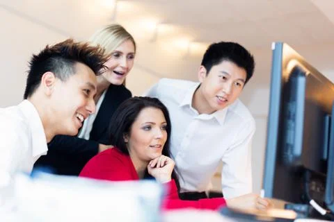 Young Creative Team Working On Their Computer 写真素材