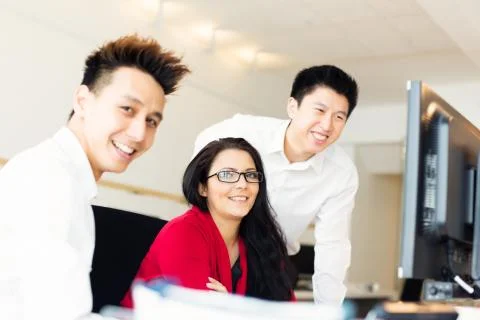 Young Creative Team Working On Their Computer Stockfoto's