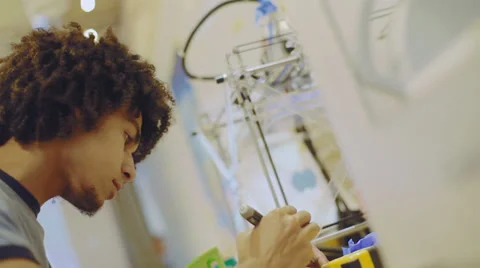 Young, creative young man experimenting with appliances and electronics Video stock 38822176