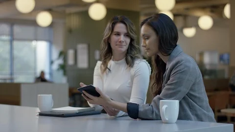 Young Creatives Collaborate Over Coffee, They Use Tablet To Brainstorm Ideas Stock Footage 97256965