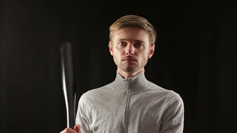 Young criminal man points baseball bat at camera Stock Footage 70414102