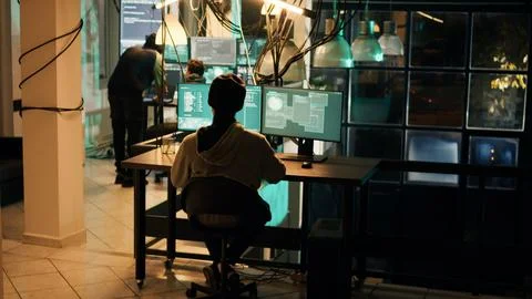 Young criminal using knowledge of technology to access valuable information Stock Photos