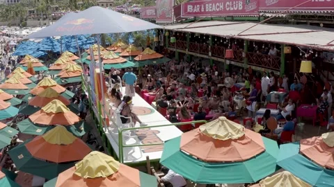 Young crowd at lively beach  bar, El Medano, Mexico Stock Footage 154928978