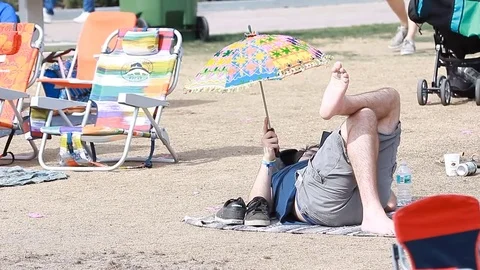 Young crowd shade with sun umbrella at an open-air music festival in summer Stock Footage 73496486