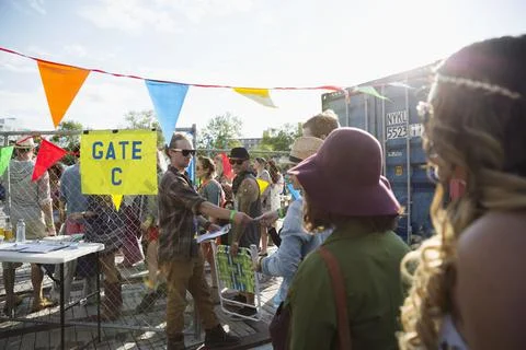 Young crowd waiting in queue at summer music festival entrance 스톡 사진