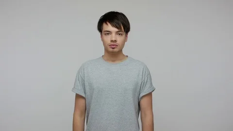 Young cunning smart guy in T-shirt rubbing hands and smiling slyly, thinking Stock Footage 124771893