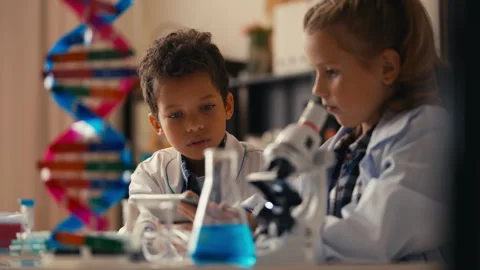 Young curious students exploring basic chemistry concepts in a science class Video stock 289317404