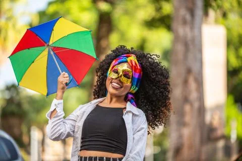 Young curly hair woman celebrating the Brazilian carnival party with Frevo um Stock Photos