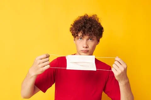 Young curly-haired man in protective masks safety posing monochrome shot Stock Photos