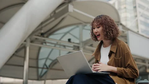 Young Curly-Haired Manager Working Online With A Laptop, Responding To Questions Stock Footage 306259837