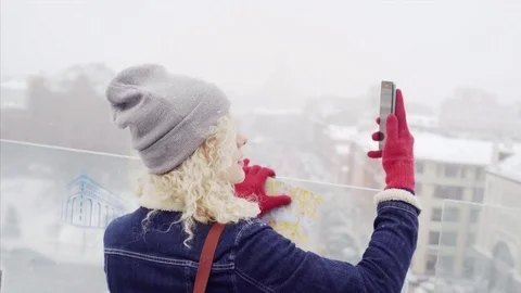 Young curly  make self-portrait on city-view Stock Footage 77798135