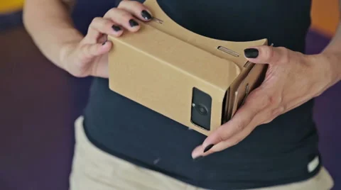 Young curly woman using Virtual Reality Glasses. Stock Footage
