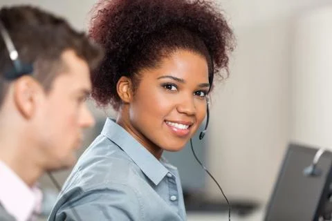 Young Customer Service Representative Working In Office Stockfoto's