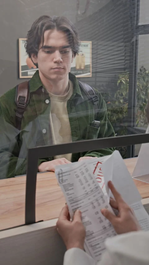 Young Customer Showing Documents to Teller Stock Footage 330964221