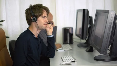 Young Customer Support Man at Callcenter Talking To Client Through Headset Stock Footage 113277236