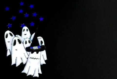 Young cut ghosts playing at scaring on starry night.One wears a witch's hat. Stock Photos