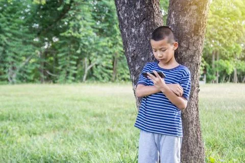 Young cute asian boy using a smartphone Foto stock