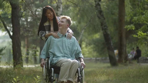 A young cute asian lady with long dark hair rolls her boyfriend in the Stock Footage 173852128