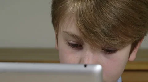 Young cute blonde boy is busy on tablet Stock Footage 47989385