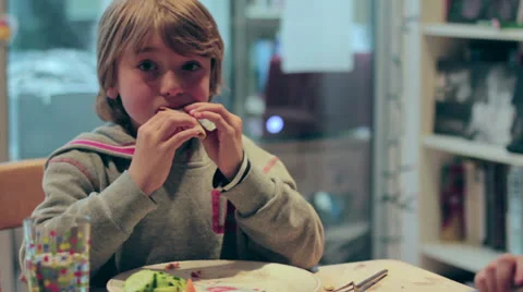 Young cute blonde boy eats pizza Video stock 24276302