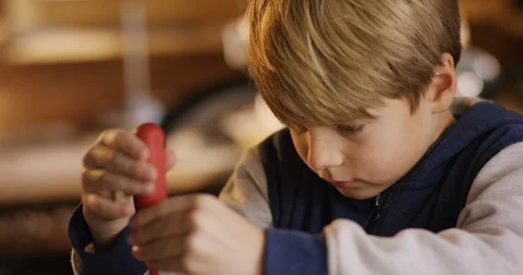 Young cute boy is screwing a screw into wood Stock Footage 85811295