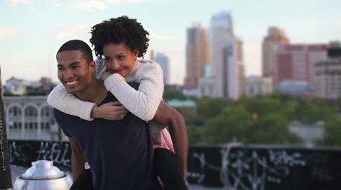 A young cute couple have fun together on a rooftop in New York Stock Footage 33999070
