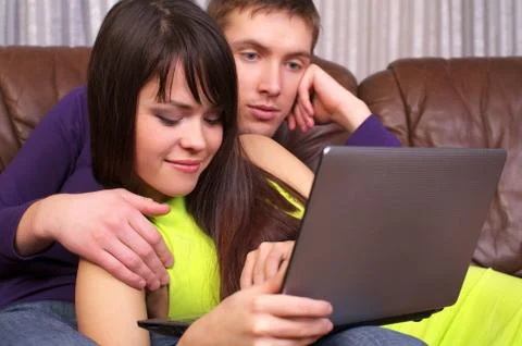 Young cute couple using a laptop Stock Photos